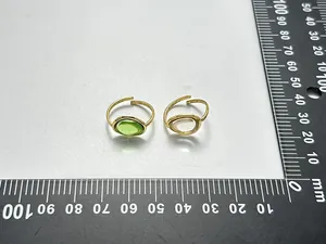 Detail view of two vintage-style gemstone open rings measured with a black metric ruler