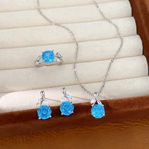 Close-up view of an elegant blue flower zircon jewelry set including necklace, ring, and earrings.