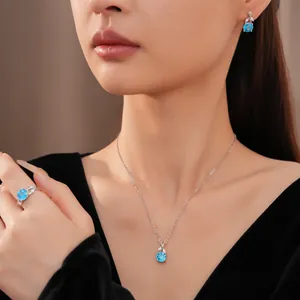 Elegant blue zircon flower pendant necklace with matching earrings and ring set on model