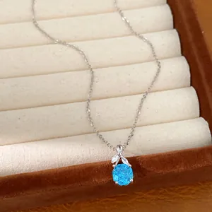 Close-up of elegant light blue zircon flower pendant on a silver necklace