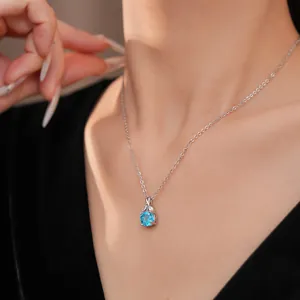 Elegant silver clavicle necklace with brilliant blue zircon flower pendant close-up