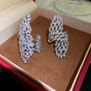 Detailed macro view of sparkly marquise zircon hollow wing rings in a luxury jewelry box