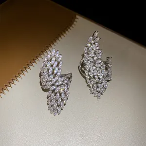 Exquisite detail of silver hollow wing ring encrusted with brilliant marquise zircon stones