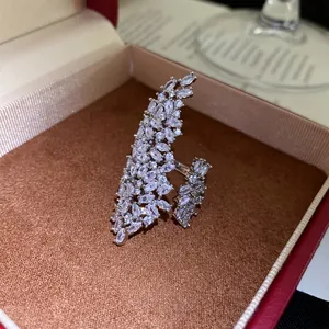 Detailed close-up of a silver geometric open ring encrusted with sparkling marquise-cut zircons