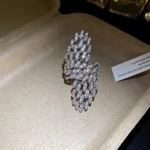 Close-up macro view of a sparkling cubic zirconia paved wing design open ring