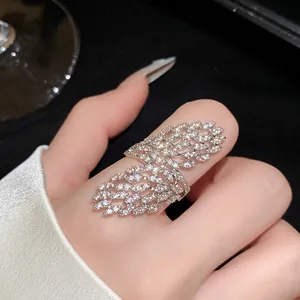 Detailed view of a silver-toned zircon open ring with an intricate hollow leaf design.
