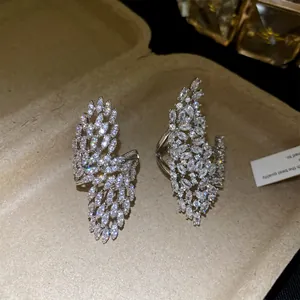 Detailed macro view of two zircon-studded openwork leaf-shaped silver statement rings