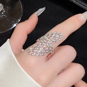Close-up of a sparkling zircon openwork geometric ring worn on a finger