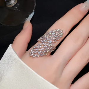 Close-up detail of an elegant zircon studded hollow geometric open ring on a hand