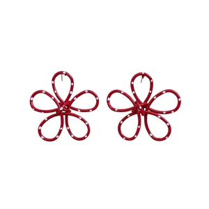 Red spray-painted metal flower stud earrings with white polka dots and silver needles