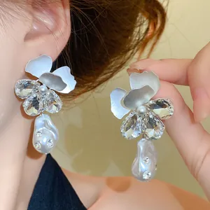 Close-up of elegant flower pearl drop earrings with rhinestones in French style