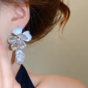 Detailed view of elegant floral pearl drop earrings with shimmering rhinestones