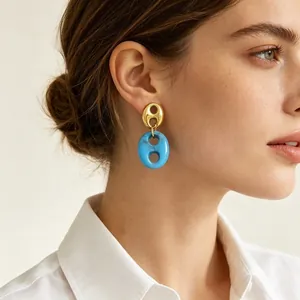 Elegant French vintage style resin dangle earrings with gold finish worn by model