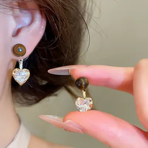 Close-up detail of Maillard style heart zircon drop earrings with brown tiger eye bead
