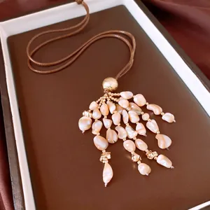 Gros plan d'un collier à pampilles en coquillages, style ethnique vintage et cordon en cuir