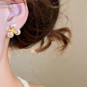 Primo piano dettagliato di un orecchino a perno con fiore di perla in stile francese sull'orecchio