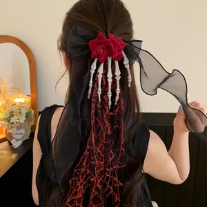 Detailed view of gothic Halloween hair clip with chiffon bow and skeleton hand decoration