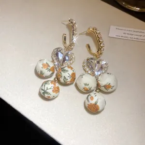 Elegant French vintage heart earrings featuring sparkling rhinestones and floral fabric beads