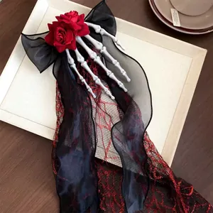 Detailed view of Gothic Halloween hair clip with skeleton hand, red roses and black bow