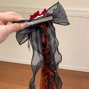 Detailed view of the back clip on a Gothic skeleton hand bow hair accessory.