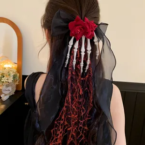 Gothic Halloween hair clip with skeleton hand bow and long red lace tassel