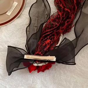 Detailed back view of a dark gothic skeleton hand hair clip with chiffon bow and metal clip
