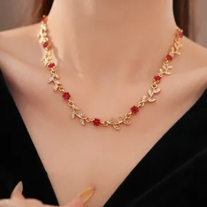 Detailed view of the exquisite gold-plated floral leaf necklace on a model's neckline