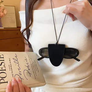 Model wearing a black leather cord sunglasses holder necklace with minimalist design
