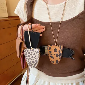 Close-up of stylish leopard print and solid color leather eyewear holder necklaces.