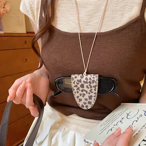 Detail shot of leopard print leather glasses holder necklace on a model