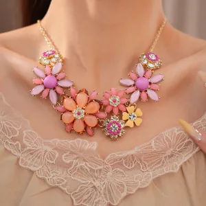 Exquisite vintage acrylic flower necklace with rhinestones worn by a model in lace