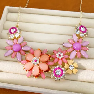 Detailed view of a vintage acrylic flower necklace featuring colorful rhinestones.