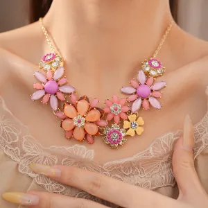 Close-up of sweet acrylic flower necklace with rhinestone accents on a model.
