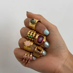 Detailed view of high-end gold-plated stainless steel rings with natural tiger eye stones