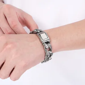 Detailed view of men's textured Cuban chain bracelet with silver spotted finish
