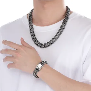 Detailed view of punk style textured stainless steel Cuban link necklace and bracelet for men