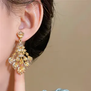 Elegant chandelier earrings featuring champagne teardrop stones and sparkling rhinestones.