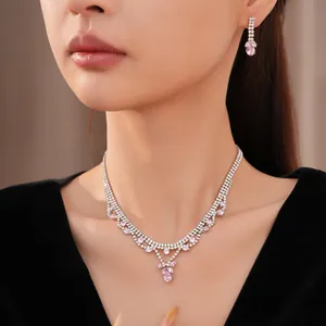 Detail view of elegant pink zircon teardrop necklace and earring set for evening gowns