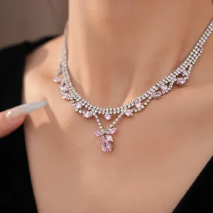 Close-up of elegant zircon necklace with pink teardrop pendant for dinner parties