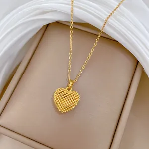 Detailed close-up of a gold-plated titanium steel hollow mesh heart pendant necklace
