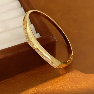 Detailed view of an 18K gold plated oval bangle bracelet featuring exquisite pavé zircon setting
