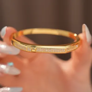 Detailed macro view of 18K gold-plated oval bangle featuring pavé cubic zirconia stones