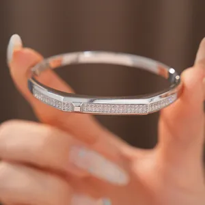 Close-up detail of a silver 18K gold plated oval bangle inlaid with sparkling zircon stones