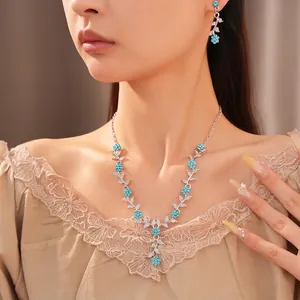 Elegant silver-tone floral leaf necklace and earring jewelry set with blue sparkling crystals