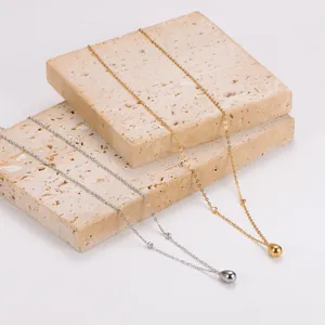 Detailopname van goud- en zilverkleurige druppelvormige hanger kettingen met diamantjes