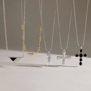 Detail shot of five diverse stainless steel necklaces featuring unique fashion pendants