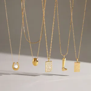 Detailed view of gold titanium steel necklaces with various trendy pendant designs
