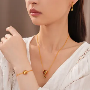 Close-up detail of the 24K gold plated enamel flower necklace and jewelry set on a model