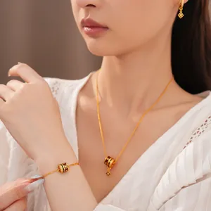 Close-up of elegant gold-plated jewelry set featuring enamel diamond flower charms