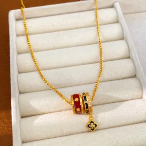 Detailed close-up of 24K gold plated necklace with enamel beads and zircon flower